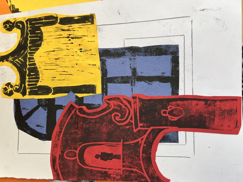 Hand-cut relief prints in red, yellow and black made in a printmaking class