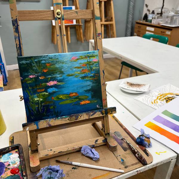 Acrylic painting of a lily pond on an easel