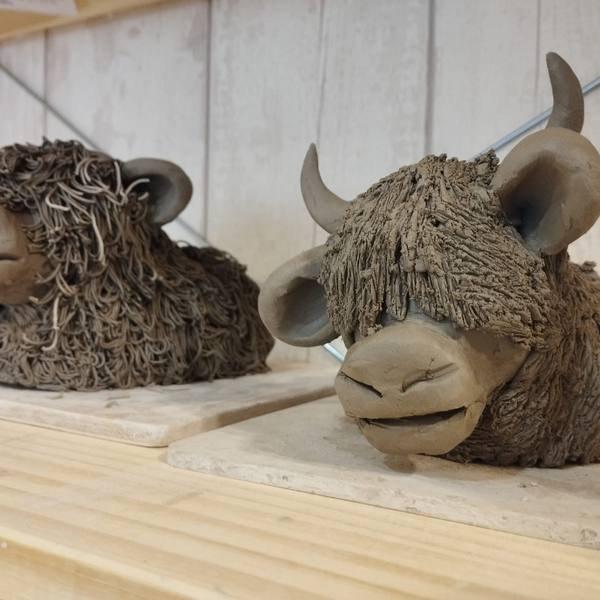 Two clay Highland Cows
