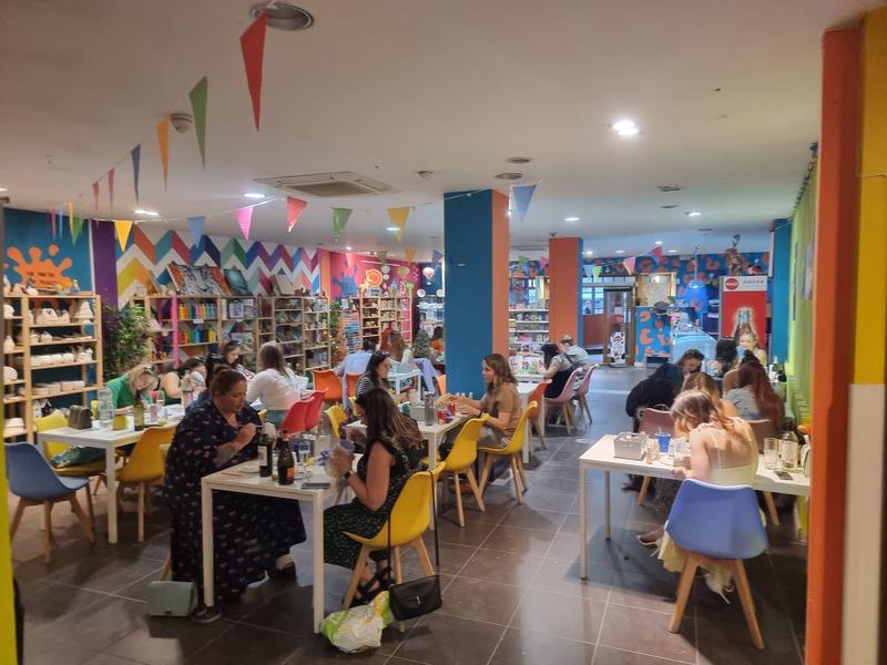 Guests painting at long tables during a mini arty party
