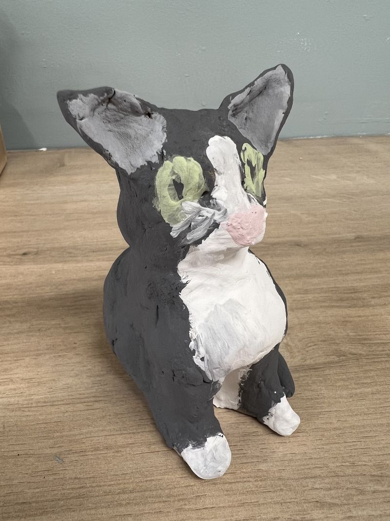 A cute hand-built clay cat character made in the studio